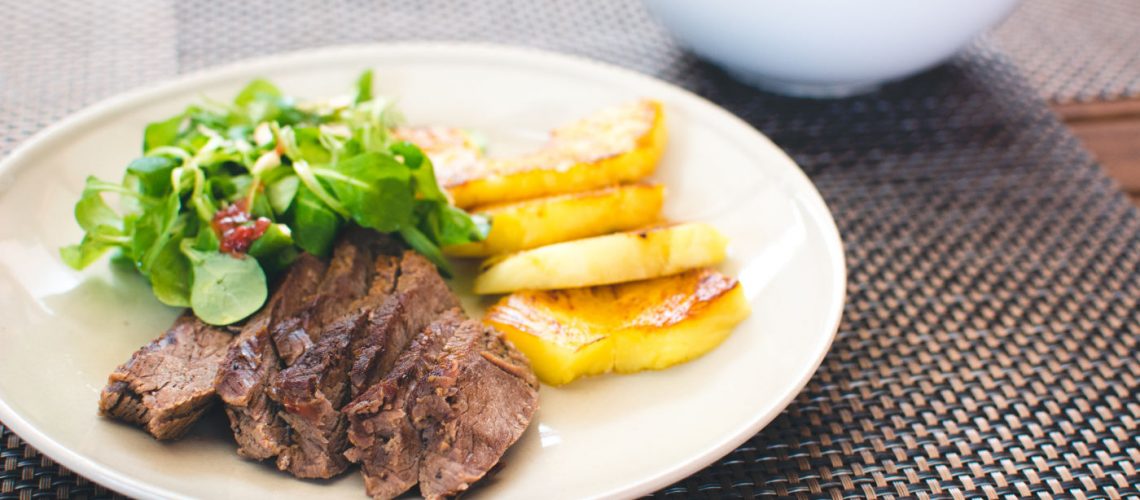 Beef steak with grilled pineapple and salad